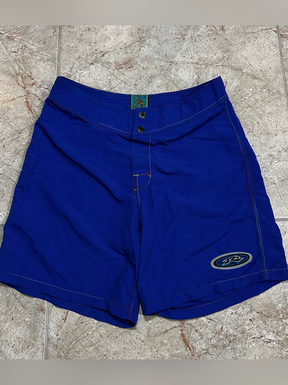 Vintage Rusty Brand men's blue board shorts in size 30